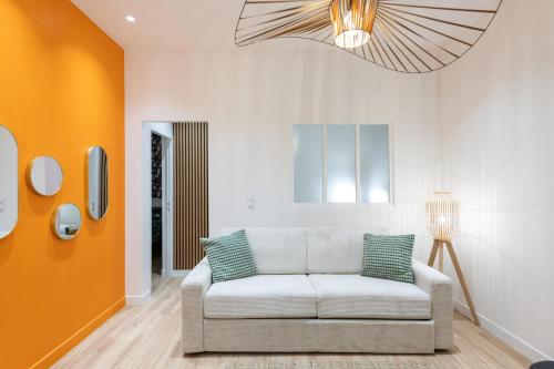 d'un salon avec un canapé blanc et un lustre. dans l'établissement Lassagne - 3, à Lyon