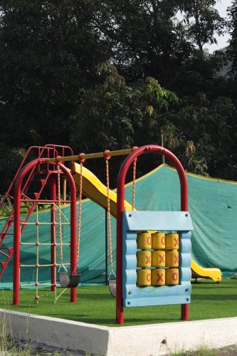 a park with a playground with a slide at Avhyay Resort in Māndvi