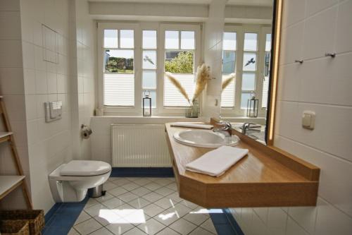 a bathroom with a sink and a toilet at Ferienwohnung mit traumhaftem Meerblick - Haus am Meer FeWo 05 in Lohme