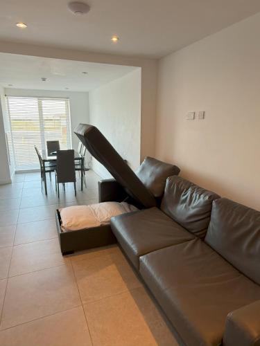 a leather couch in a living room with a table at Coastal Plaza in Blackpool