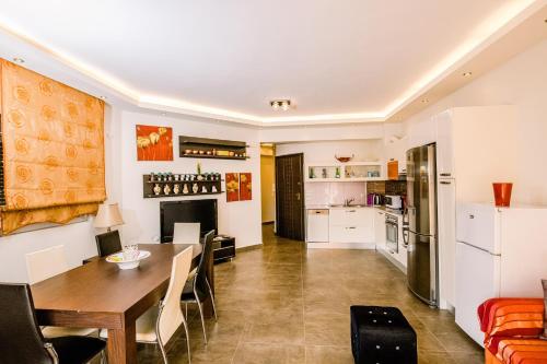 Una cocina y un comedor con mesa y sillas. en Mary's modern apartment, en Kissamos