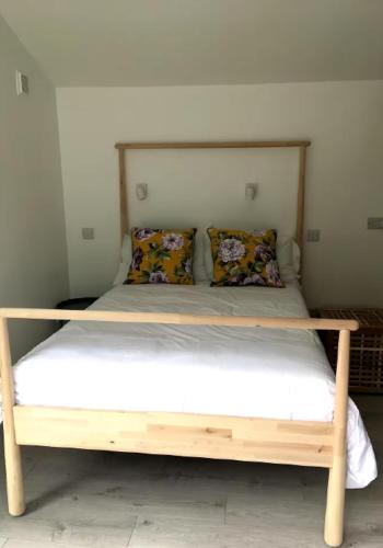 a bed with a wooden frame in a room at The Strand Inn in Dunmore East