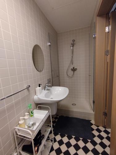 a bathroom with a sink and a toilet and a shower at Chessboard apartment in old town Riga, Coffee included in Rīga
