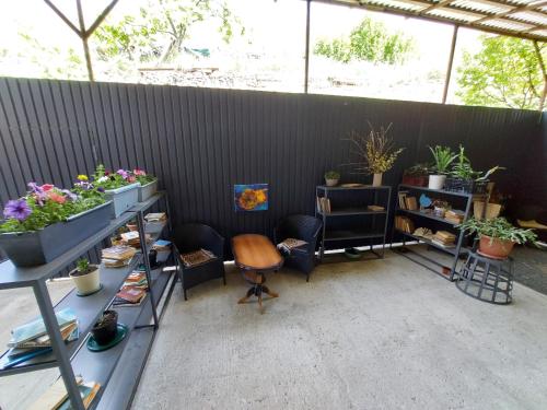 a room with a lot of plants and chairs at Komfort Ilona in Yerevan