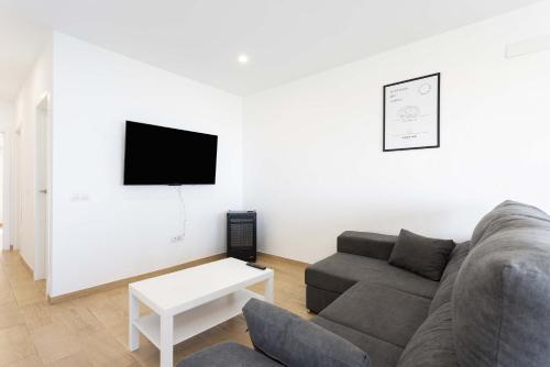 a living room with a couch and a tv at Las Ranas 1 in El Durazno