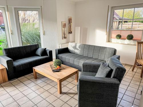 a living room with two couches and a coffee table at Holiday Home Christa - HOK110 by Interhome in Hooksiel