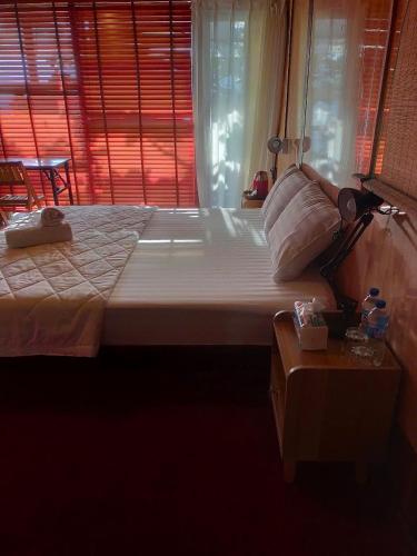 a bedroom with a large bed with a window at Cham Island Wooden Cabin in Hoi An