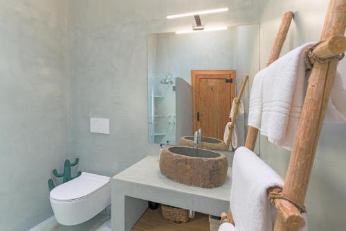 a bathroom with a sink and a toilet at Monte da Torre in Melides