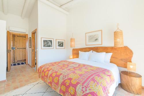 a bedroom with a large bed in a room at Monte da Torre in Melides