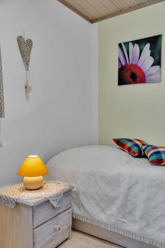 a bedroom with a bed and a table with a lamp at Chalet Friedrichsen I by Interhome in Langenhorn