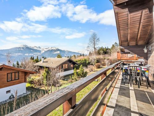 a deck with a view of the mountains at Chalet Moulinettes 8 by Interhome in Bluche