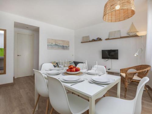 a white dining room with a white table and chairs at Apartment Marinada by Interhome in Tossa de Mar