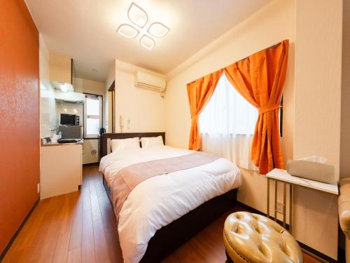 a bedroom with a large bed and a window at Asakusa 4min walk, 8min to Senso-ji Temple, 5min to Ueno,4 min to Kappabashi, Switch, Free Wi-Fi, PocketWi-Fi in Tokyo