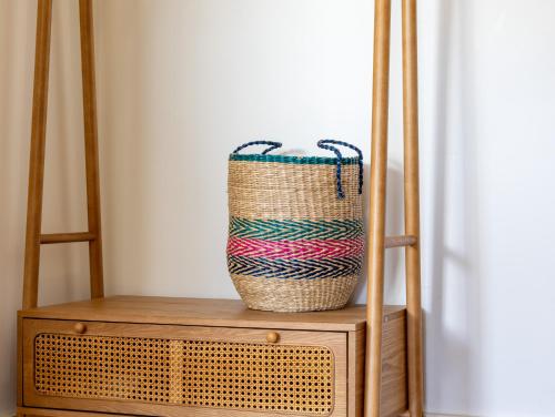 a basket sitting on top of a wooden shelf at Pieds Dans L'eau Madame est Servie in Trébeurden