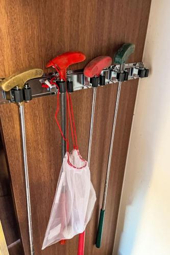 a group of four golf clubs hanging on a wall at Chalet Waldrauschen by Interhome in Bad Arolsen