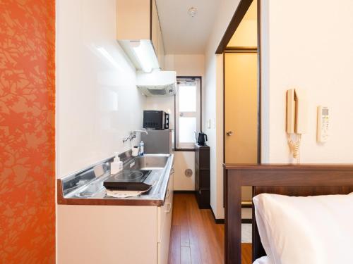 a small kitchen with a sink in a room at Asakusa 4min walk, 8min to Senso-ji Temple, 5min to Ueno,4 min to Kappabashi, Switch, Free Wi-Fi, PocketWi-Fi in Tokyo