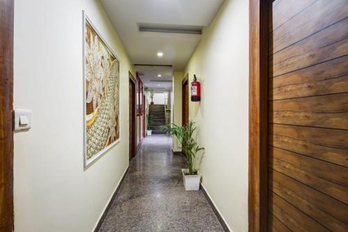 a hallway of a house with a plant at Hotel Armani Deluxe By SMART GROUP in New Delhi
