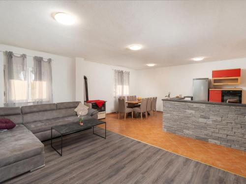 a living room with a couch and a table at Holiday Home Angels Retreat by Interhome in Maslenica