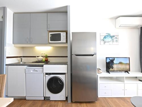 une cuisine avec un réfrigérateur et un lave-vaisselle dans l'établissement Studio Village Cap Estérel - L'Esquinade-106 by Interhome, à Agay