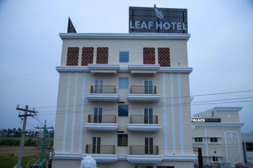 a hotel building with a sign on top of it at Leaf Hotel in Tiruvannāmalai
