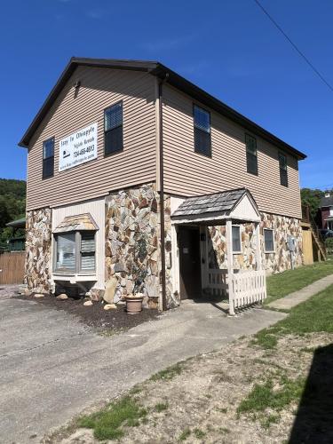 a church with a stone building with a garage at Stay In Ohiopyle - closest place to the GAP trail in Ohiopyle, PA, Hot Tub in Ohiopyle