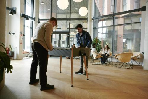 two men playing a game on a table in an office at Canvas Arundel House in Coventry in Coventry