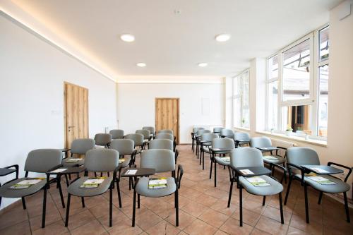 a room with chairs and tables and windows at Amenity Apartmány Perná in Perná