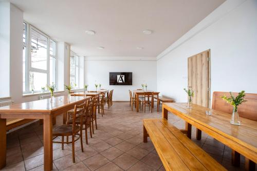a dining room with wooden tables and chairs at Amenity Apartmány Perná in Perná