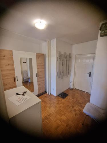 a room with a white counter and a wooden floor at Apartman Wish in Belgrade