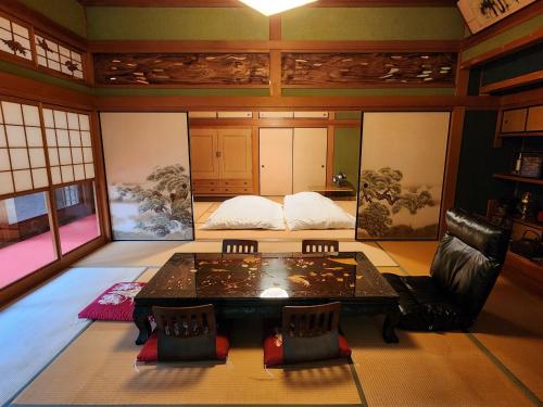 a room with a table and chairs in a room at Samurai House! Seen in Movies and Dramas near HIKOSAN !! in Soida