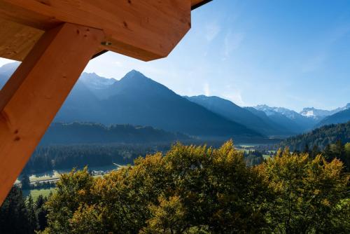a view of the mountains from a log cabin at Hotel Bergflair in Fischen