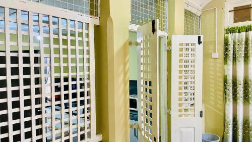 a hallway with yellow walls and white doors at The Old Manor - Weligama in Weligama