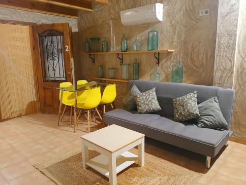 a living room with a couch and a table at Casa Estrella in Villafamés