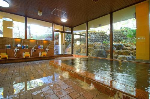 a large room with a pool of water in a building at Hotel Kinu in Nikko
