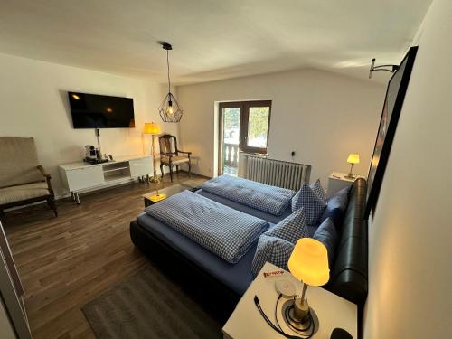 a living room with a bed and a couch at Haus Fremerey in Krün