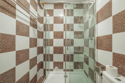 a bathroom with a shower and a tub at Rossio Suites By Hosty in Lisbon