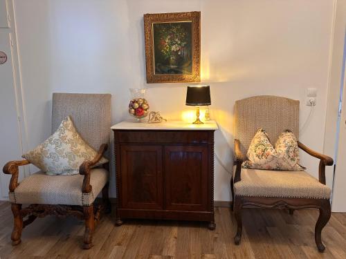 two chairs sitting next to a table with a lamp at Haus Fremerey in Krün