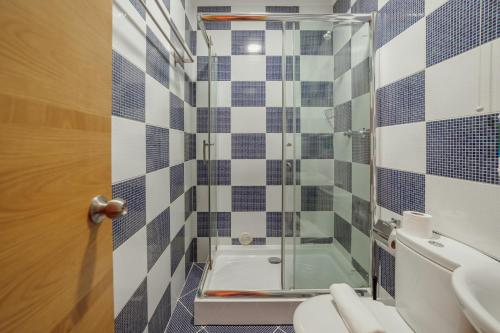 a bathroom with a shower and a toilet and a sink at Rossio Suites By Hosty in Lisbon