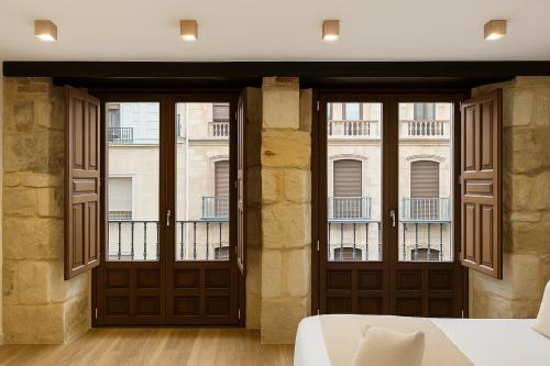 Katil atau katil-katil dalam bilik di Rua Mayor MSuites