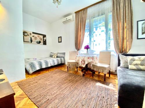 a living room with a couch and a table at Apartment Rustico Belgrade in Belgrade