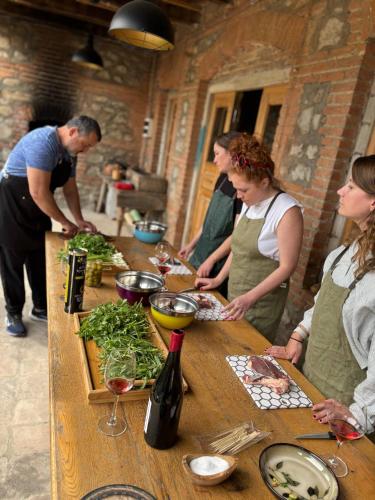 a group of people standing around a table preparing food at Kardanakhi Estate in Anaga