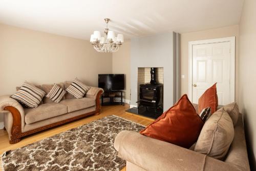 a living room with a couch and a television at Loch View House in Loch Gowna in Lough Gowna