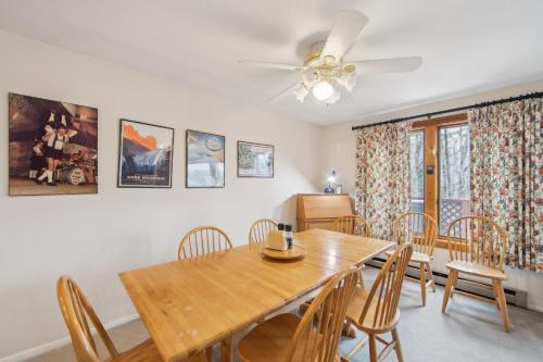 a dining room with a wooden table and chairs at Chatiemac 42F - Quiet & Cozy 3-Bedroom Retreat in North Creek