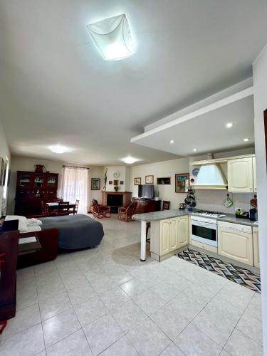 a kitchen and a living room with a bed and a table at Appartamento tra il borgo e il lago in Anguillara Sabazia