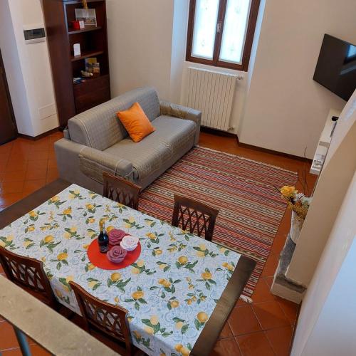 a living room with a table and a couch at 1 STEP ON THE LAKE in Clusane sul Lago