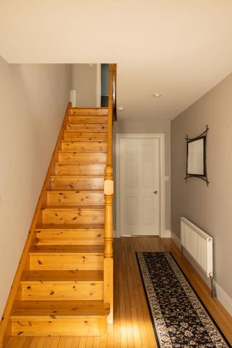 a wooden staircase in a room with a door at Loch View House in Loch Gowna in Lough Gowna