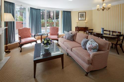 a living room with a couch and a table at Cheval Thorney Court at Hyde Park in London