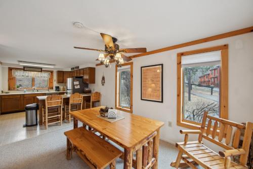 a dining room and kitchen with a wooden table and chairs at Lower Darby in North Creek
