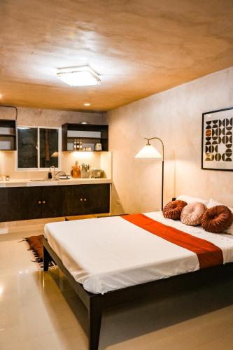 a bedroom with a large bed and a kitchen at DMall Central Stn 2 Near Beach in Boracay