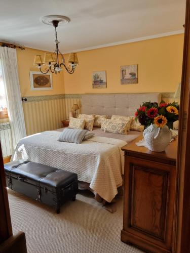 a bedroom with a large bed with flowers on it at Gaztañeta Baserria in Olaeta